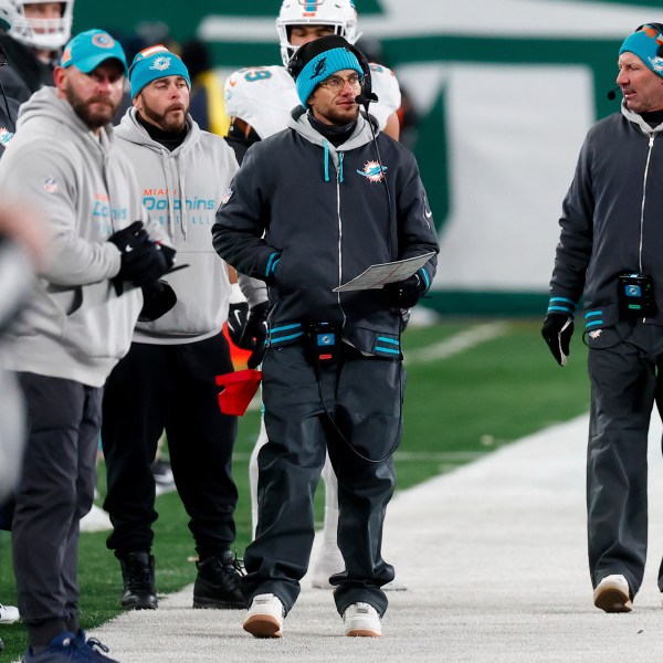 Miami Dolphins head coach Mike McDaniels, center, walks on the sideline during the second half of an NFL football game against the New York Jets, Sunday, Jan. 5, 2025, in East Rutherford, N.J. (AP Photo/Noah K. Murray)