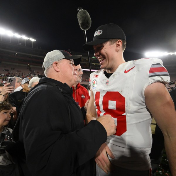 Ohio State offensive coordinator Chip Kelly, left, celebrates with quarterback Will Howard (18) after the quarterfinals of the Rose Bowl College Football Playoff against Oregon, Wednesday, Jan. 1, 2025, in Pasadena, Calif. (AP Photo/Kyusung Gong)