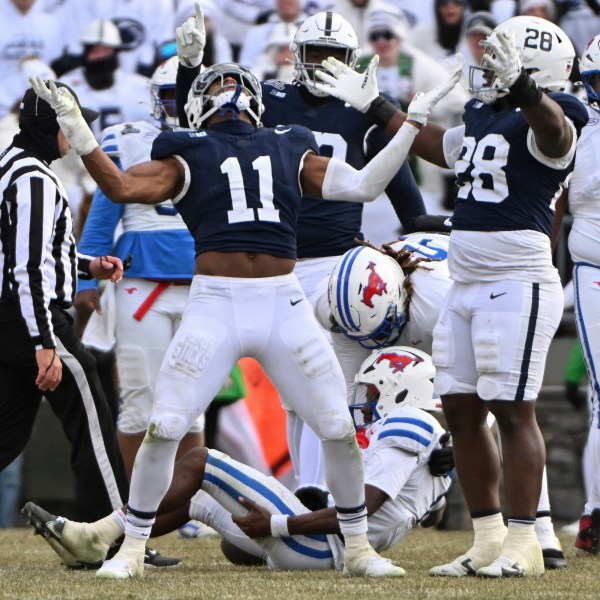 Penn State defensive end Abdul Carter (11) celebrates after sacking SMU quarterback Kevin Jennings during the second half in the first round of the College Football Playoff, Saturday, Dec. 21, 2024, in State College, Pa. (AP Photo/Barry Reeger)