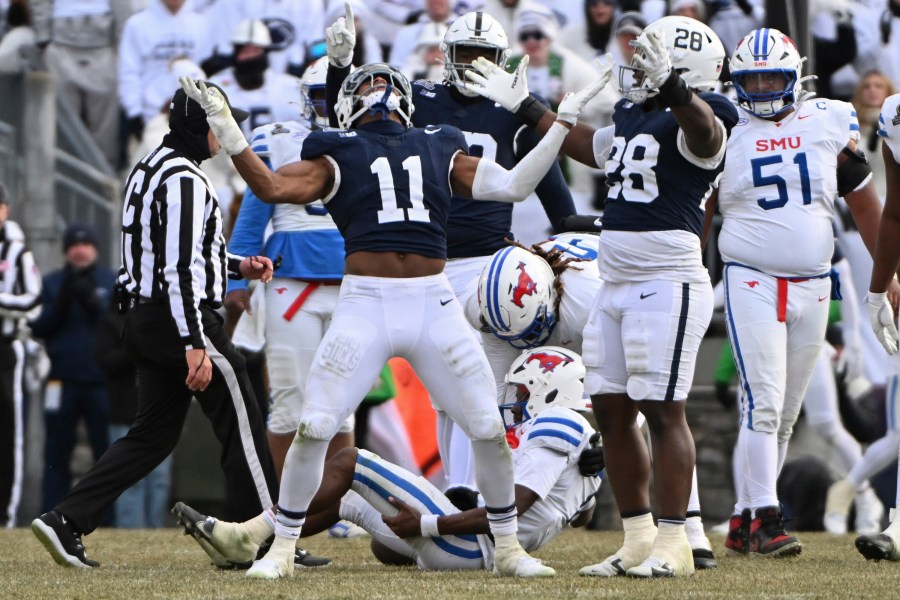 Penn State defensive end Abdul Carter (11) celebrates after sacking SMU quarterback Kevin Jennings during the second half in the first round of the College Football Playoff, Saturday, Dec. 21, 2024, in State College, Pa. (AP Photo/Barry Reeger)