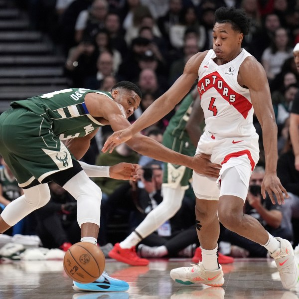 Toronto Raptors forward Scottie Barnes (4) steals the ball from Milwaukee Bucks forward Giannis Antetokounmpo during the first half of an NBA basketball game in Toronto, Monday, Jan. 6, 2025. (Nathan Denette/The Canadian Press via AP)