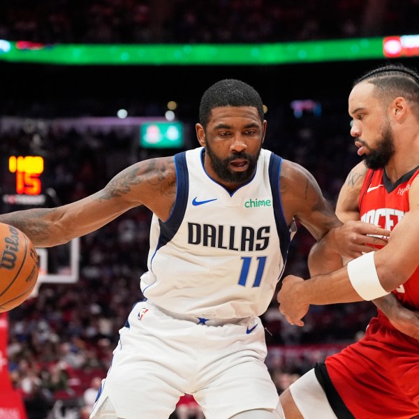 Dallas Mavericks' Kyrie Irving (11) is defended by Houston Rockets' Dillon Brooks during the first half of an NBA basketball game Wednesday, Jan. 1, 2025, in Houston. (AP Photo/David J. Phillip)