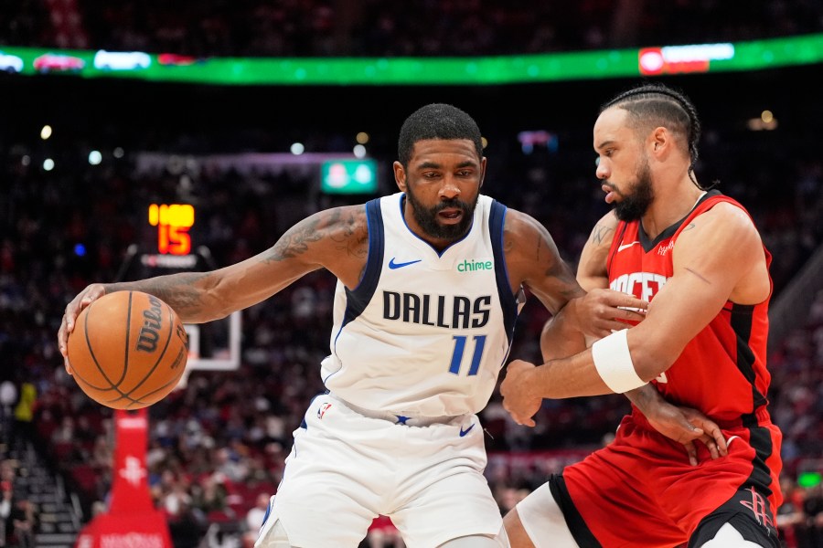 Dallas Mavericks' Kyrie Irving (11) is defended by Houston Rockets' Dillon Brooks during the first half of an NBA basketball game Wednesday, Jan. 1, 2025, in Houston. (AP Photo/David J. Phillip)