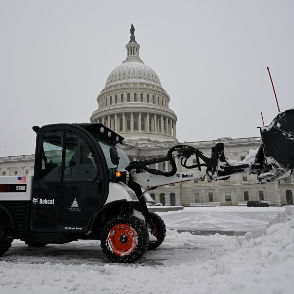 A front end loader clears a heavy early morning snow fall on the east side of the Capitol ahead of a joint session of Congress to certify the votes from the Electoral College in the presidential election, Monday, Jan. 6, 2025, in Washington. (AP Photo/John McDonnell)