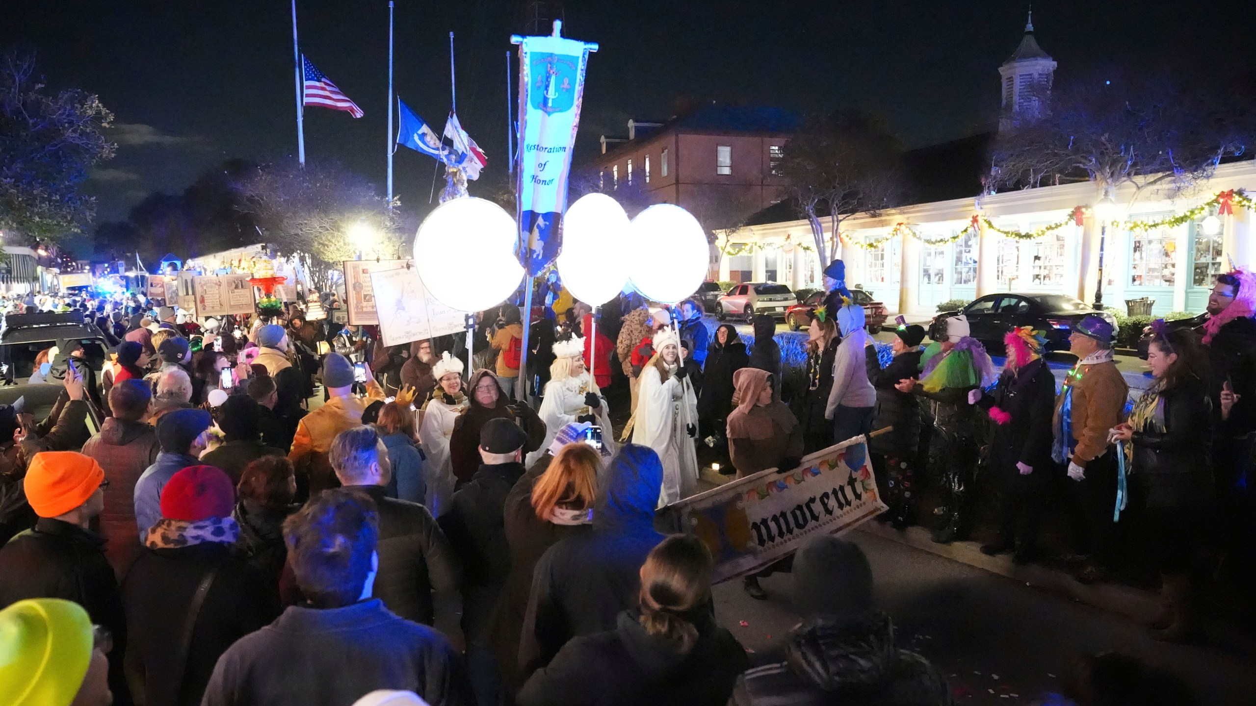 Parade-goers walk during the annual Krewe de Jeanne d'Arc parade, kicking off the Mardi Gras season, in New Orleans, Monday, Jan. 6, 2025. (AP Photo/Gerald Herbert)