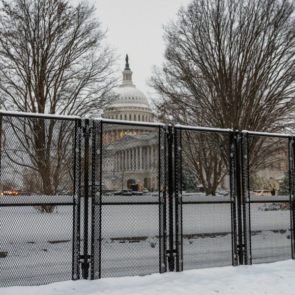 Security fencing surrounds Capitol Hill as snow blankets the region ahead of a joint session of Congress to certify the votes from the Electoral College in the presidential election, in Washington, Monday, Jan. 6, 2025. (AP Photo/J. Scott Applewhite)