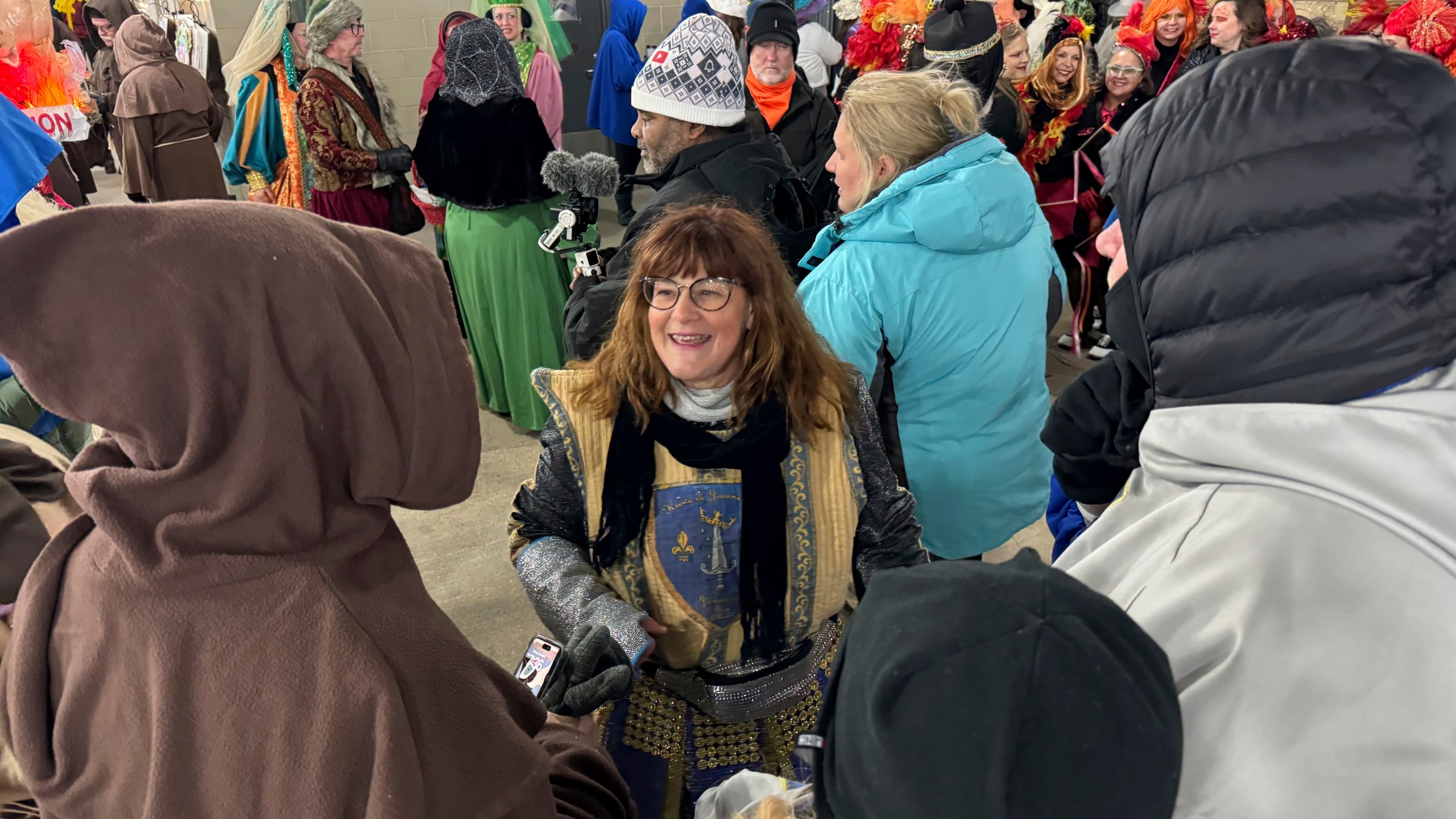 Antoinette de Alteriis, co-captain of the Krewe de Jeanne d'Arc, organizes volunteers before the start of the Joan of Arc parade on Monday, Jan. 6, 2025, in New Orleans. (AP Photo/Jack Brook)