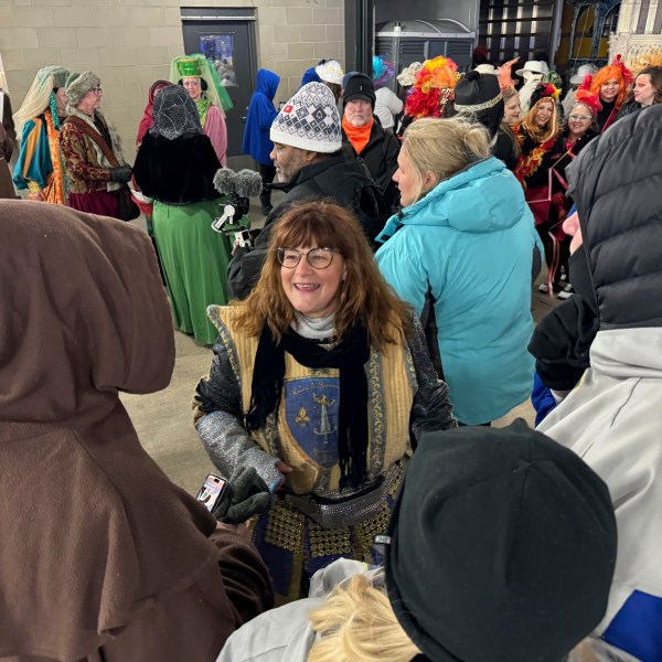 Antoinette de Alteriis, co-captain of the Krewe de Jeanne d'Arc, organizes volunteers before the start of the Joan of Arc parade on Monday, Jan. 6, 2025, in New Orleans. (AP Photo/Jack Brook)