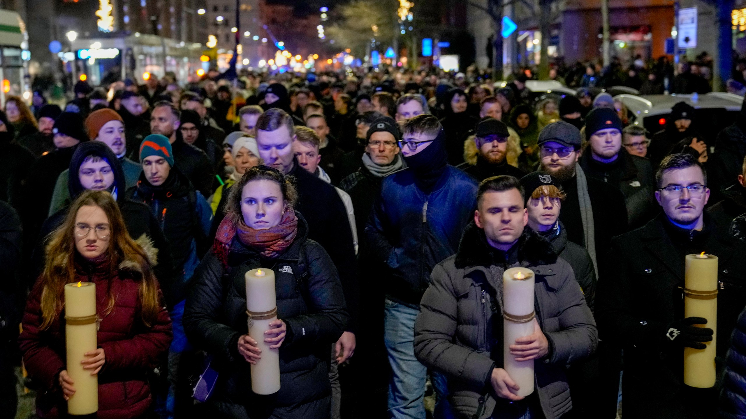 FILE - People carry candles attending an AfD election campaign in front of the cathedral in Magdeburg, Germany, on Dec. 23, 2024. (AP Photo/Ebrahim Noroozi, File)