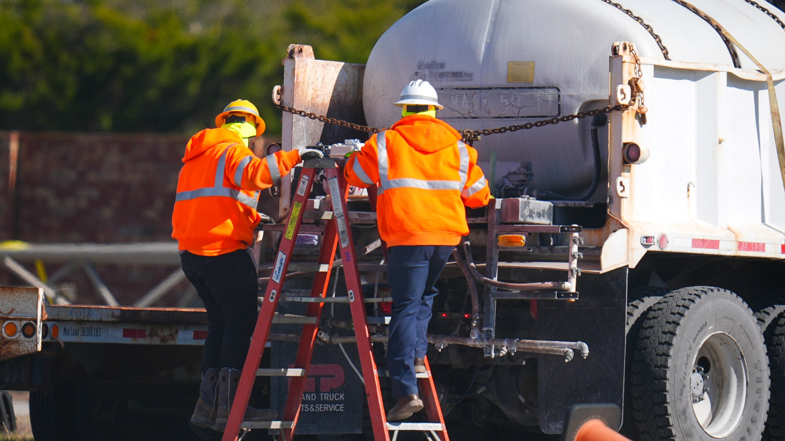 Workers labor on a brine truck at the Texas Department of Transportation Dallas Southwest lot as crews prepare the roads ahead of a winter storm expected to hit the North Texas region, Tuesday, Jan. 7, 2025, in Cedar Hill, Texas. (AP Photo/Julio Cortez)