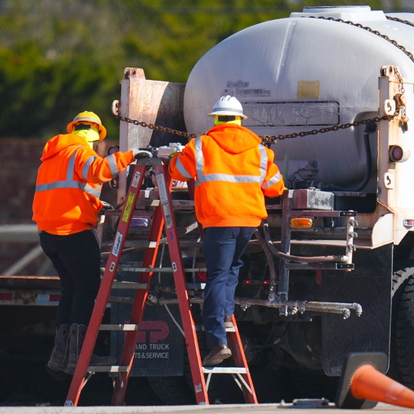 Workers labor on a brine truck at the Texas Department of Transportation Dallas Southwest lot as crews prepare the roads ahead of a winter storm expected to hit the North Texas region, Tuesday, Jan. 7, 2025, in Cedar Hill, Texas. (AP Photo/Julio Cortez)