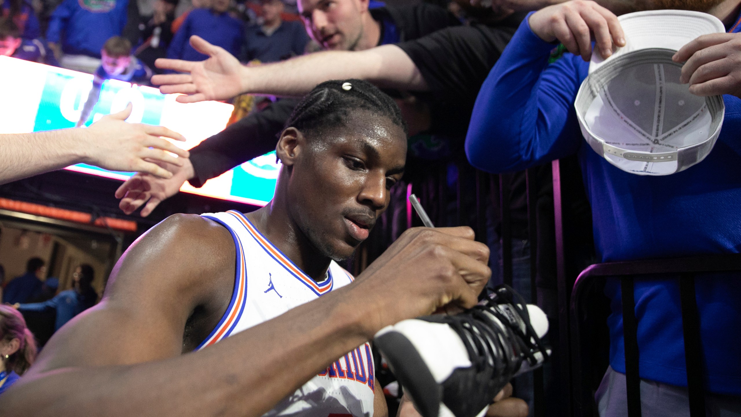 Florida center Rueben Chinyelu (9) signs a shoe after defeating Tennessee 73-43 in an NCAA college basketball game Tuesday, Jan. 7, 2025, in Gainesville, Fla. (AP Photo/Alan Youngblood)