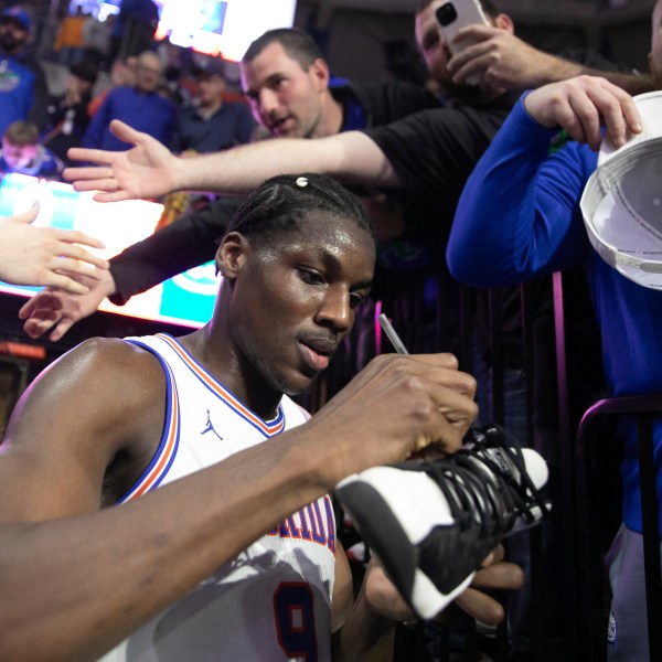 Florida center Rueben Chinyelu (9) signs a shoe after defeating Tennessee 73-43 in an NCAA college basketball game Tuesday, Jan. 7, 2025, in Gainesville, Fla. (AP Photo/Alan Youngblood)