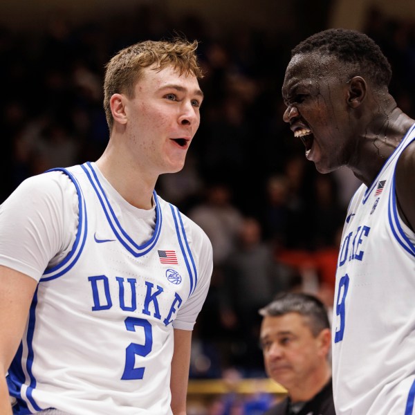 Duke's Cooper Flagg (2) reacts with Khaman Malauch (9) after a dunk during the second half of an NCAA college basketball game agaist Pittsburgh in Durham, N.C., Tuesday, Jan. 7, 2025. (AP Photo/Ben McKeown)