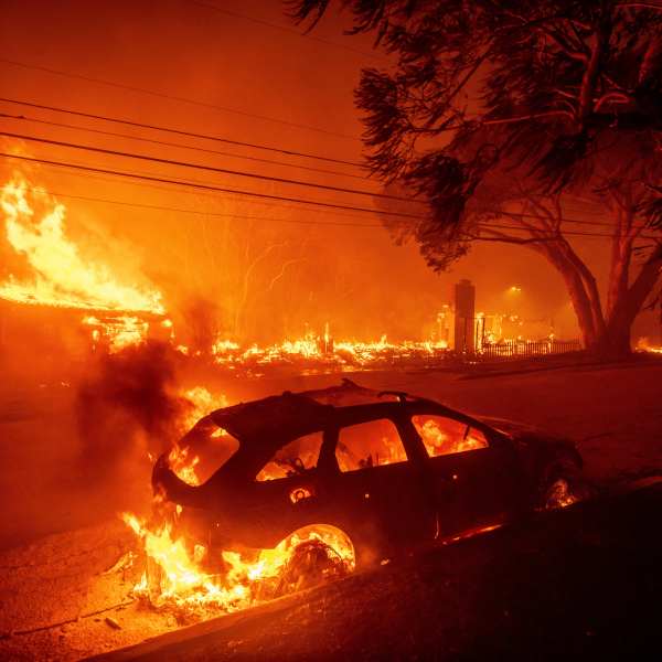 The Palisades Fire burns vehicles and structures in the Pacific Palisades neighborhood of Los Angeles, Tuesday, Jan. 7, 2025. (AP Photo/Ethan Swope)