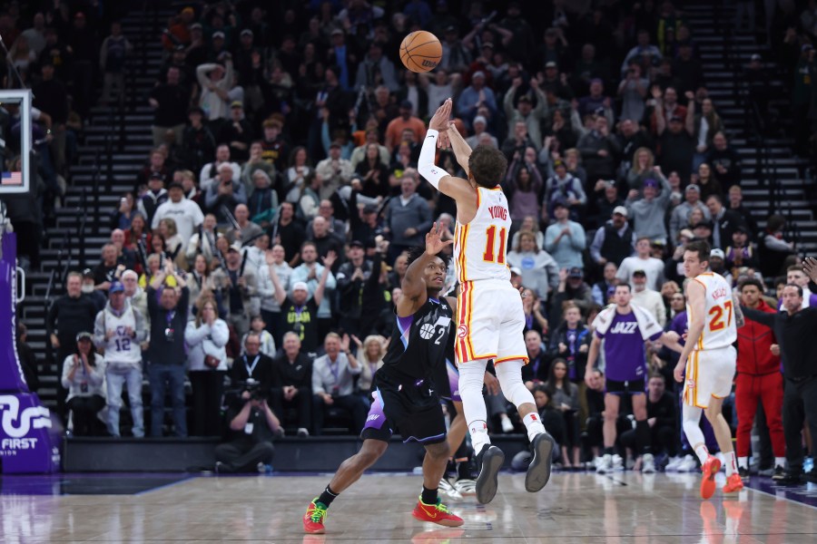 Atlanta Hawks guard Trae Young (11) shoots a three point shot from half court over Utah Jazz guard Collin Sexton (2) at the buzzer to win an NBA basketball game, Tuesday, Jan. 7, 2025, in Salt Lake City. (AP Photo/Rob Gray)