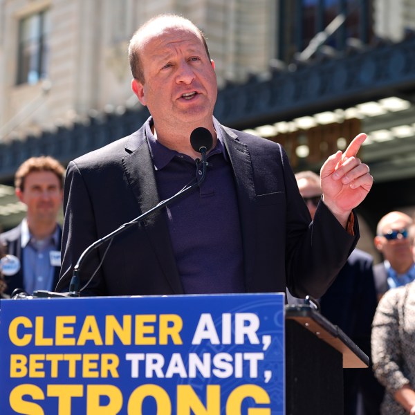 FILE - Colorado Gov. Jared Polis speaks before signing into law a surface transportation infrastructure development bill to help connect the state with a passenger rail system during a ceremony May 16, 2024, in front of Union Station in lower downtown Denver. (AP Photo/David Zalubowski, File)