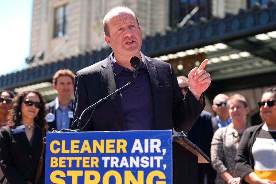 FILE - Colorado Gov. Jared Polis speaks before signing into law a surface transportation infrastructure development bill to help connect the state with a passenger rail system during a ceremony May 16, 2024, in front of Union Station in lower downtown Denver. (AP Photo/David Zalubowski, File)