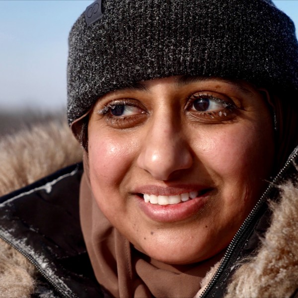 Ruqayah Nasser takes a break after her first snow tubing runs in below-zero cold during an outing organized by a Minnesota group promoting outdoors activities by Muslim women, at Elm Creek Park Reserve in Maple Grove, Minn., on Jan. 4, 2025. (AP Photo/Mark Vancleave)