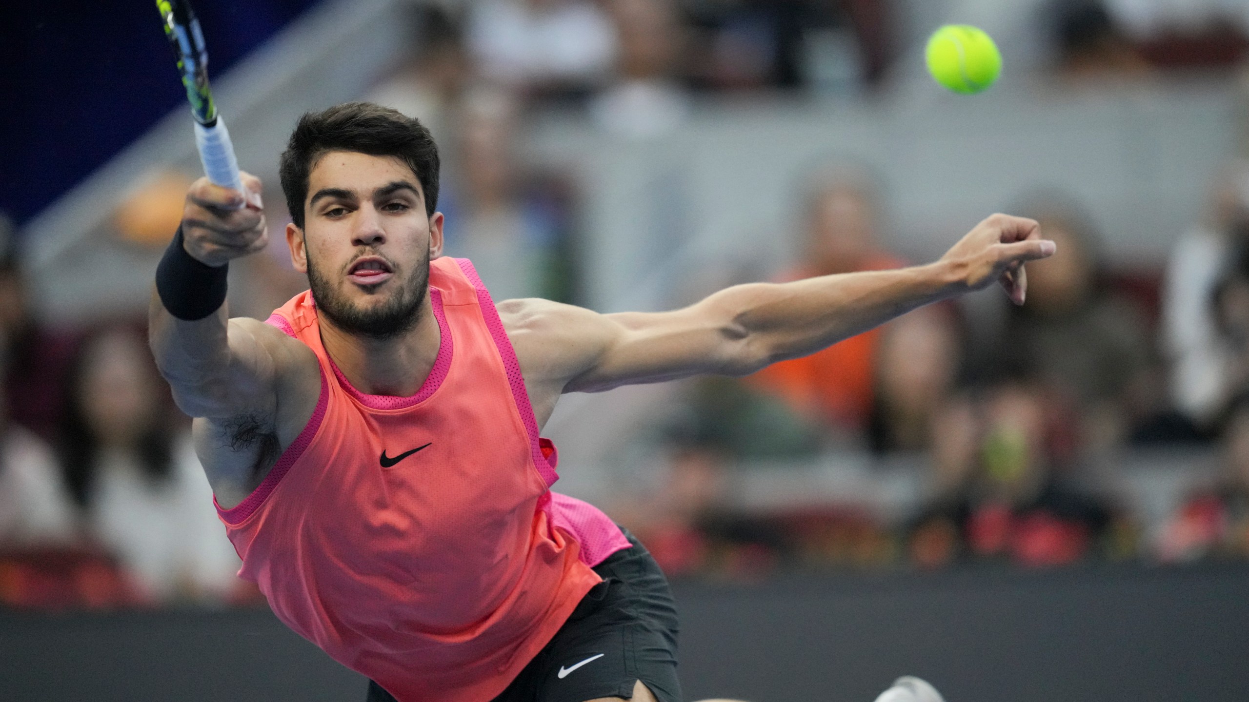 FILE - Carlos Alcaraz of Spain returns a shot from Jannik Sinner of Italy during their men's singles finals match of the China Open tennis tournament, at the National Tennis Center in Beijing, Wednesday, Oct. 2, 2024. (AP Photo/Achmad Ibrahim, File)