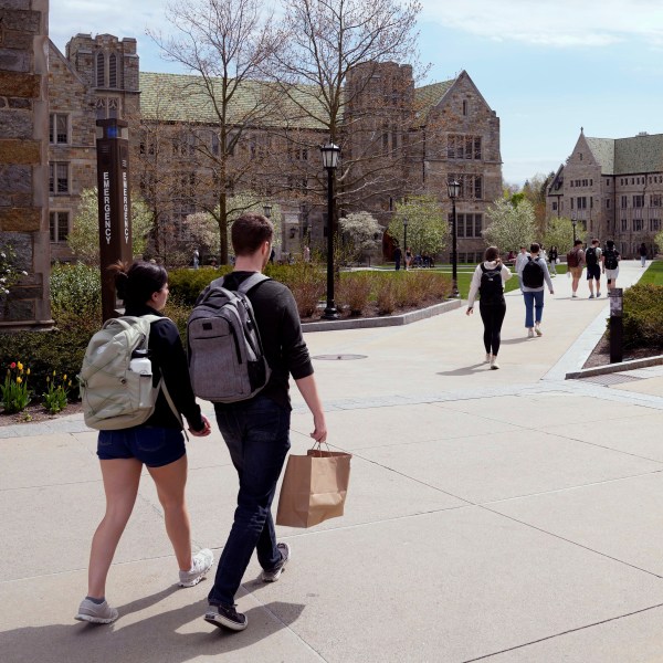 FILE - Students walk on the campus of Boston College, Monday, April 29, 2024, in Boston. . (AP Photo/Charles Krupa, File)