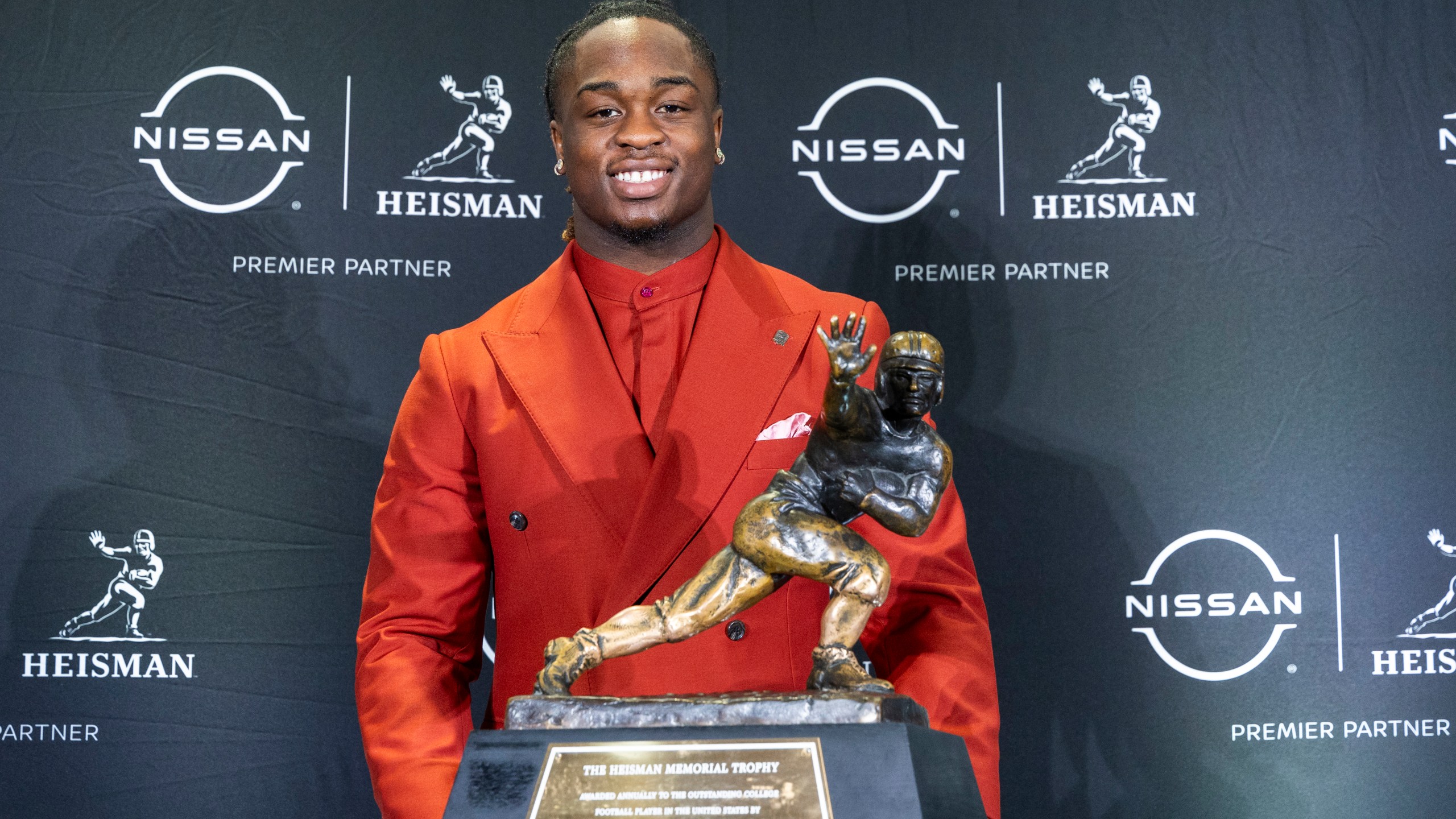 Heisman Trophy finalist Ashton Jeanty, of Boise State, stands with the trophy during a college football press conference, Saturday, Dec. 14, 2024, in New York. (AP Photo/Corey Sipkin)