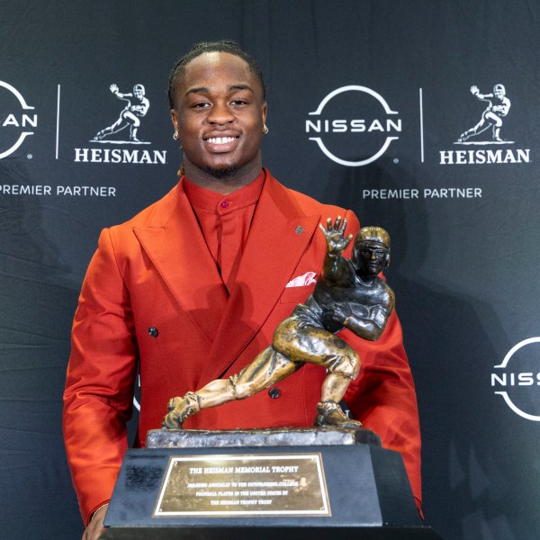 Heisman Trophy finalist Ashton Jeanty, of Boise State, stands with the trophy during a college football press conference, Saturday, Dec. 14, 2024, in New York. (AP Photo/Corey Sipkin)