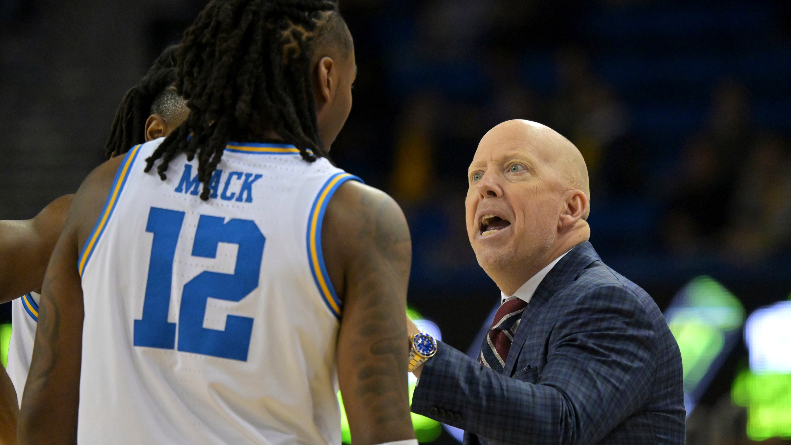 UCLA head coach Mick Cronin instructs UCLA guard Sebastian Mack (12) during the first half of an NCAA college basketball game against Michigan, Tuesday, Jan. 7, 2025, in Los Angeles. (AP Photo/Jayne Kamin-Oncea)