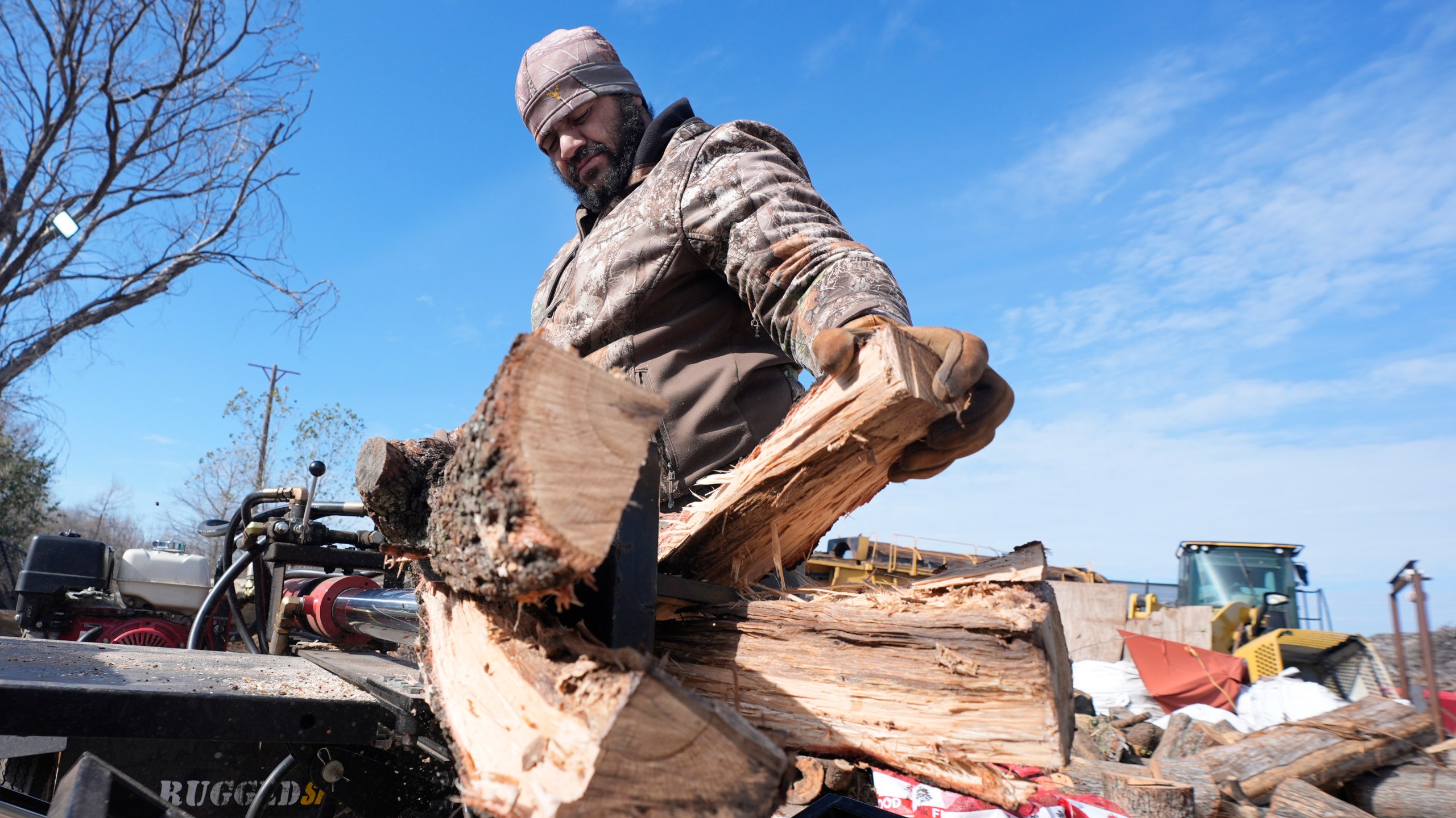 Sterling Howard splits logs for firewood ahead of a winter storm expected to hit the North Texas region later tomorrow Wednesday, Jan. 8, 2025, in Dallas. (AP Photo/LM Otero)