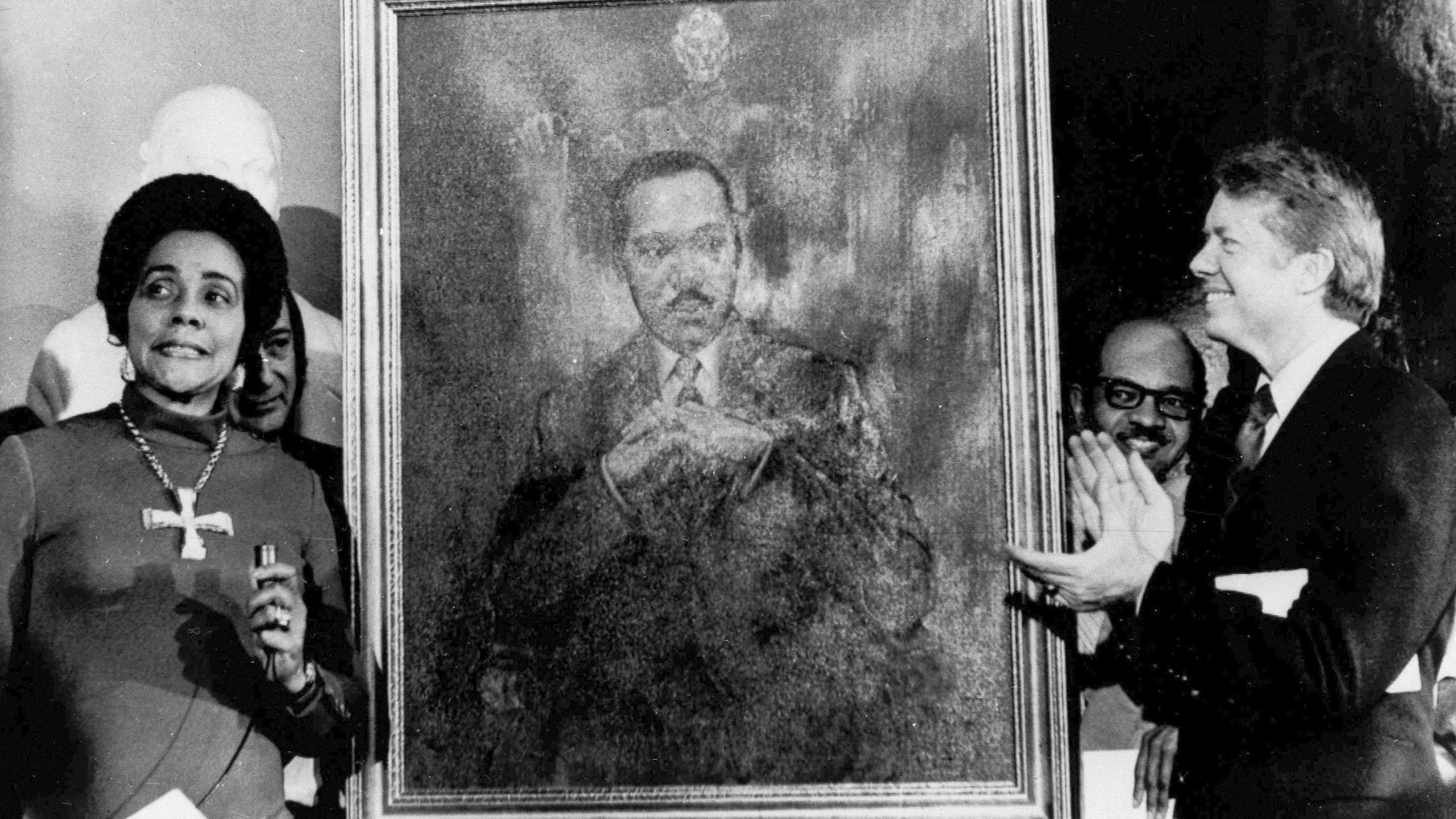 FILE - Coretta Scott King, widow of slain civil rights leader Martin Luther King Jr., speaks at an unveiling of a portrait of Martin Luther King by artist George Mandus on Feb. 18, 1974, while Gov. Jimmy Carter, right, looks on. (AP Photo/File)