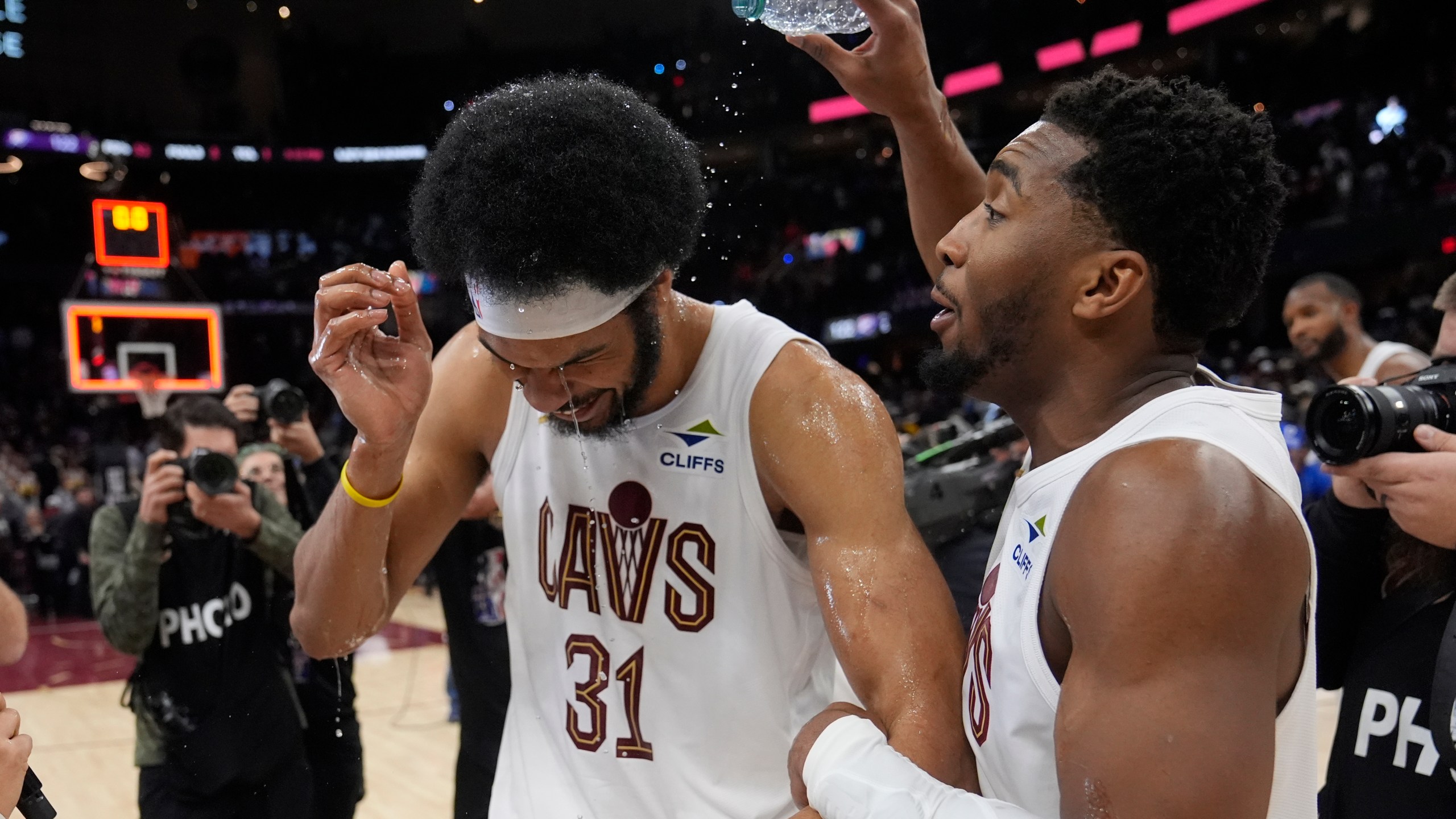 Cleveland Cavaliers guard Donovan Mitchell, right, celebrates with Jarrett Allen (31) after the Cavaliers defeated the Oklahoma City Thunder in an NBA basketball game, Wednesday, Jan. 8, 2025, in Cleveland. (AP Photo/Sue Ogrocki)