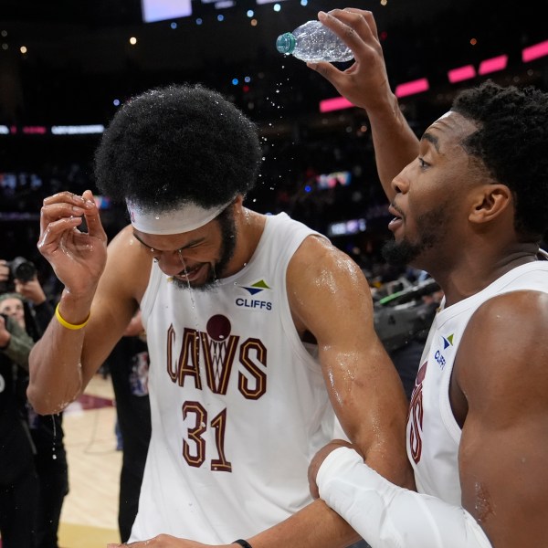 Cleveland Cavaliers guard Donovan Mitchell, right, celebrates with Jarrett Allen (31) after the Cavaliers defeated the Oklahoma City Thunder in an NBA basketball game, Wednesday, Jan. 8, 2025, in Cleveland. (AP Photo/Sue Ogrocki)