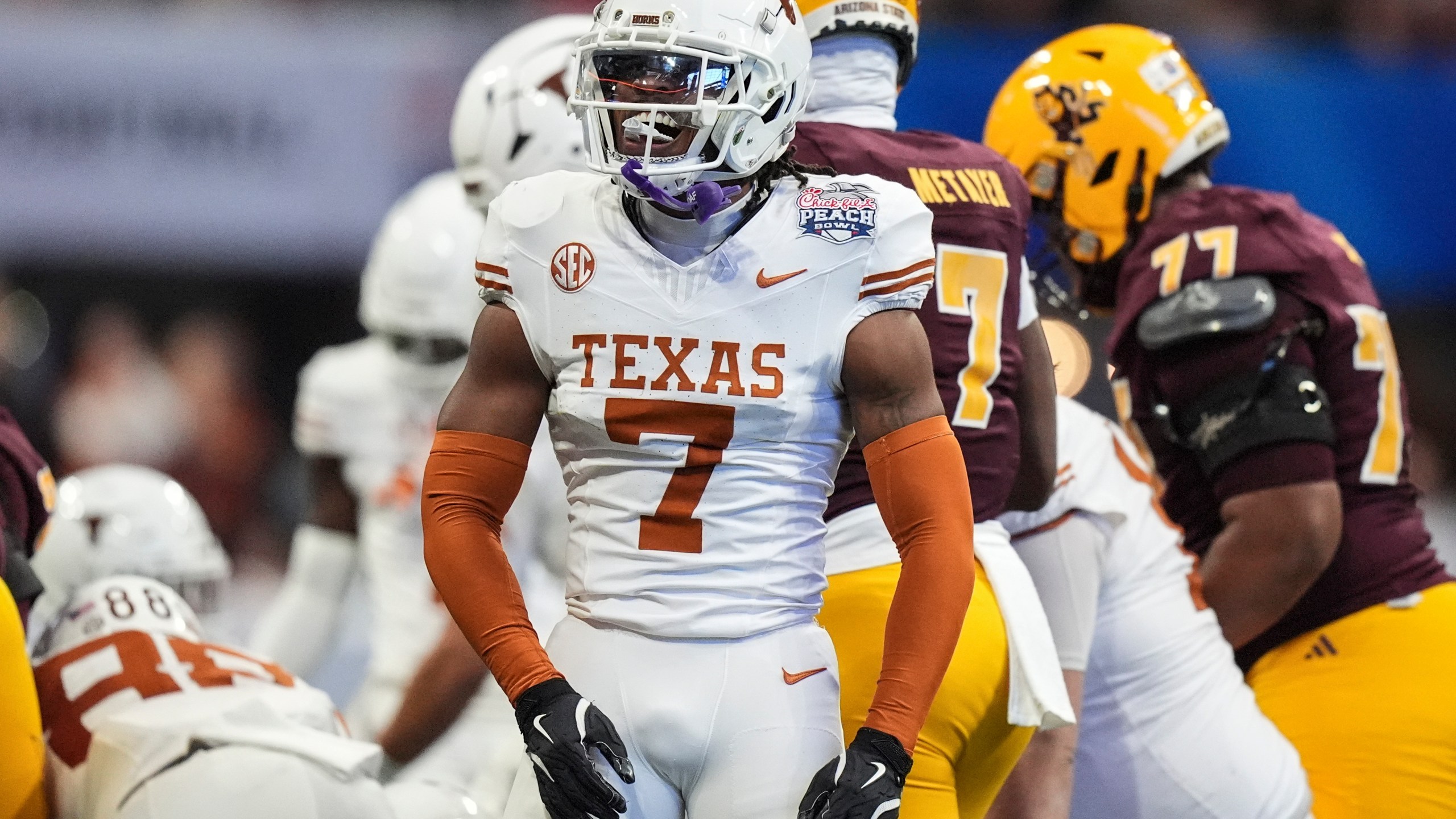 Texas defensive back Jahdae Barron (7) celebrates a defensive play against Arizona State during the first half in the quarterfinals of a College Football Playoff, Wednesday, Jan. 1, 2025, in Atlanta. (AP Photo/Brynn Anderson)