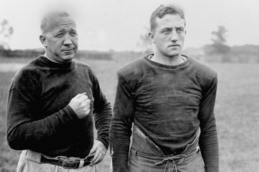 FILE - Notre Dame football coach Knute Rockne, left, and team captain Clem Crowe watch the team practice in 1925. (AP Photo/File)