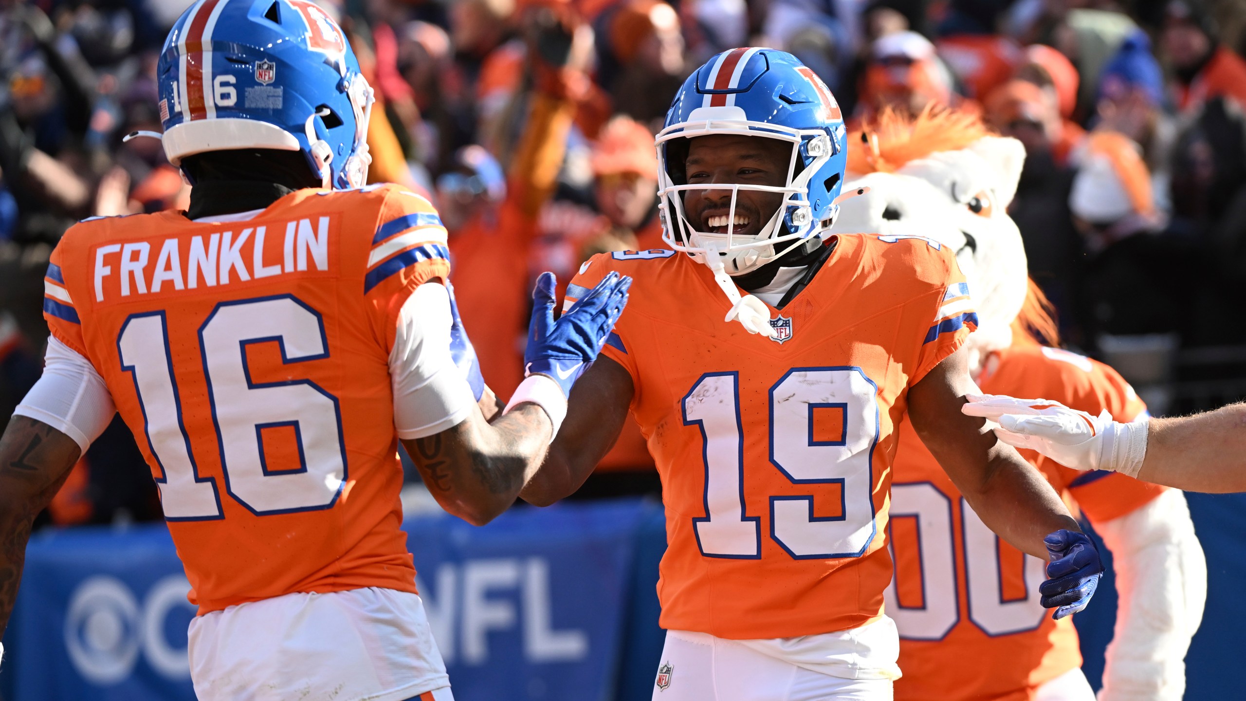 Denver Broncos wide receiver Marvin Mims Jr. (19) is congratulated by teammate Troy Franklin (16) after scoring during the first half of an NFL football game against the Kansas City Chiefs Sunday, Jan. 5, 2025, in Denver. (AP Photo/Geneva Heffernan)