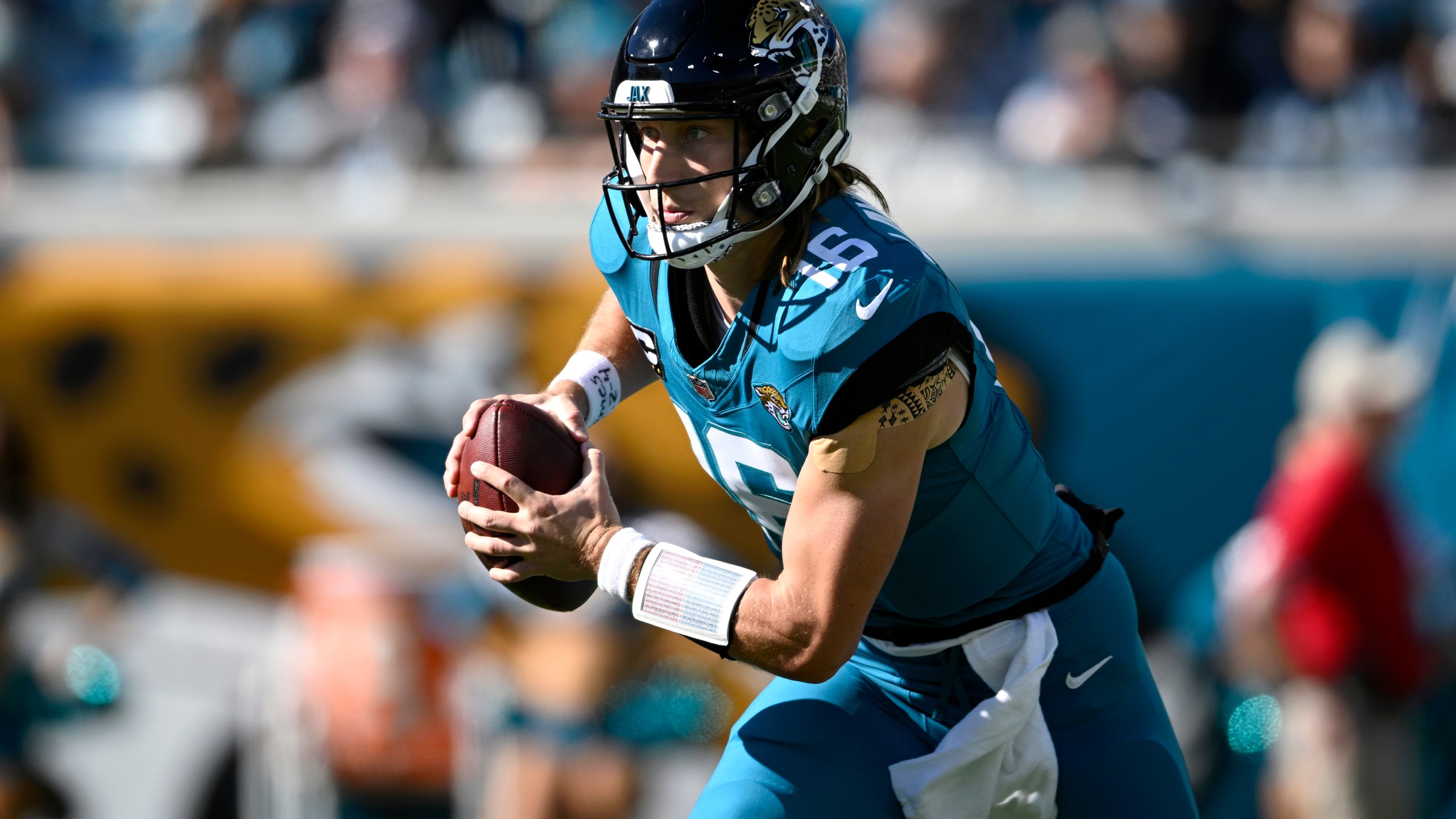 FILE - Jacksonville Jaguars quarterback Trevor Lawrence (16) scrambles for yardage against the Houston Texans during the first half of an NFL football game, Sunday, Dec. 1, 2024, in Jacksonville, Fla. (AP Photo/Phelan M. Ebenhack, File)