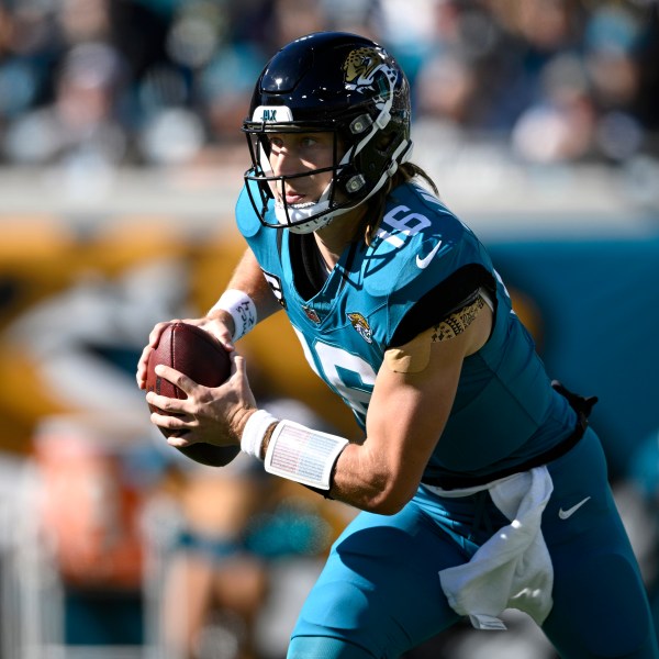 FILE - Jacksonville Jaguars quarterback Trevor Lawrence (16) scrambles for yardage against the Houston Texans during the first half of an NFL football game, Sunday, Dec. 1, 2024, in Jacksonville, Fla. (AP Photo/Phelan M. Ebenhack, File)