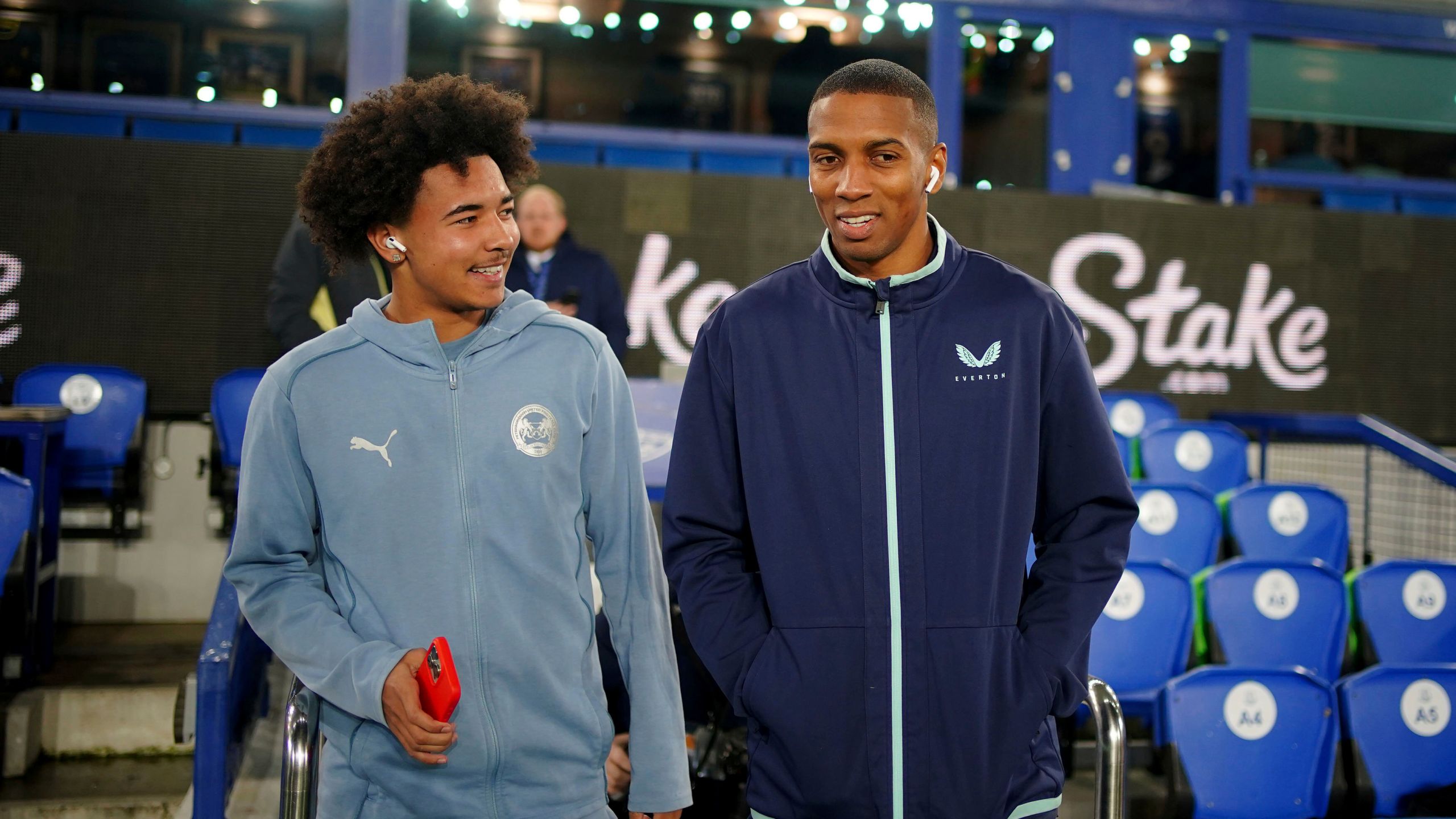 Everton's Ashley Young, right, speaks with his son, Peterborough United's Tyler Young, before the Emirates FA Cup third round match at Goodison Park, Liverpool, England, Thursday Jan. 9, 2025. (Peter Byrne/PA via AP)