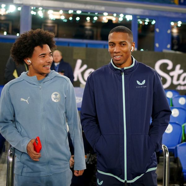 Everton's Ashley Young, right, speaks with his son, Peterborough United's Tyler Young, before the Emirates FA Cup third round match at Goodison Park, Liverpool, England, Thursday Jan. 9, 2025. (Peter Byrne/PA via AP)