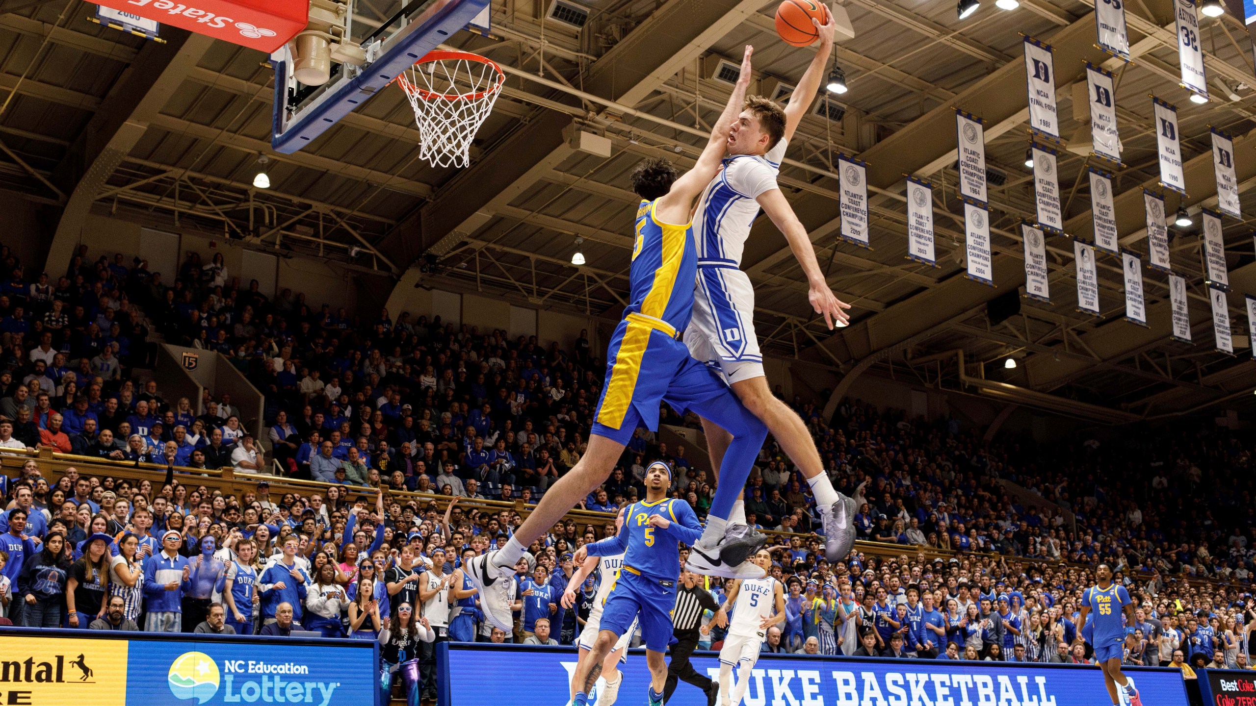 Duke's Cooper Flagg, right, dunks over Pittsburgh's Guillermo Diaz Graham (25) during the second half of an NCAA college basketball game in Durham, N.C., Tuesday, Jan. 7, 2025. (AP Photo/Ben McKeown)