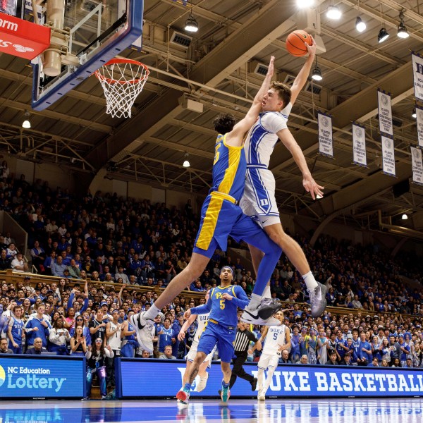 Duke's Cooper Flagg, right, dunks over Pittsburgh's Guillermo Diaz Graham (25) during the second half of an NCAA college basketball game in Durham, N.C., Tuesday, Jan. 7, 2025. (AP Photo/Ben McKeown)