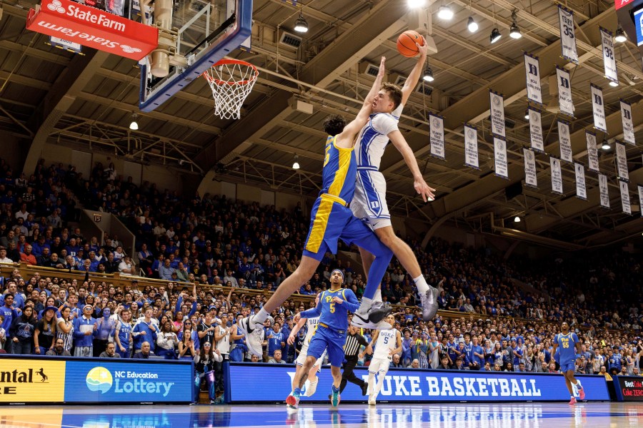 Duke's Cooper Flagg, right, dunks over Pittsburgh's Guillermo Diaz Graham (25) during the second half of an NCAA college basketball game in Durham, N.C., Tuesday, Jan. 7, 2025. (AP Photo/Ben McKeown)