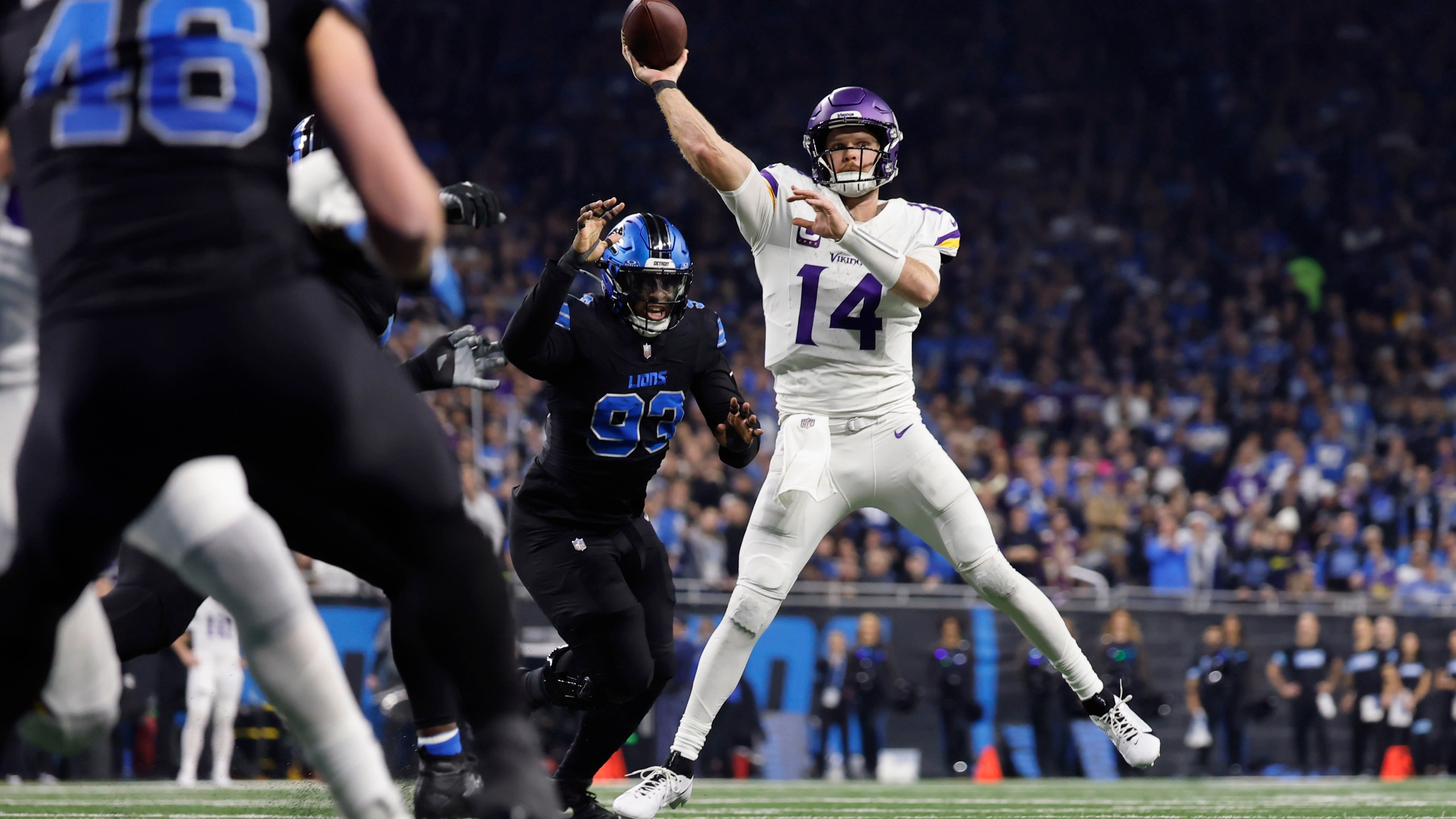 Minnesota Vikings quarterback Sam Darnold (14) throws against the Detroit Lions during the first half of an NFL football game Sunday, Jan. 5, 2025, in Detroit. (AP Photo/Rey Del Rio)