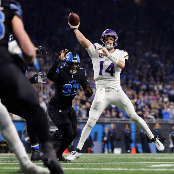 Minnesota Vikings quarterback Sam Darnold (14) throws against the Detroit Lions during the first half of an NFL football game Sunday, Jan. 5, 2025, in Detroit. (AP Photo/Rey Del Rio)