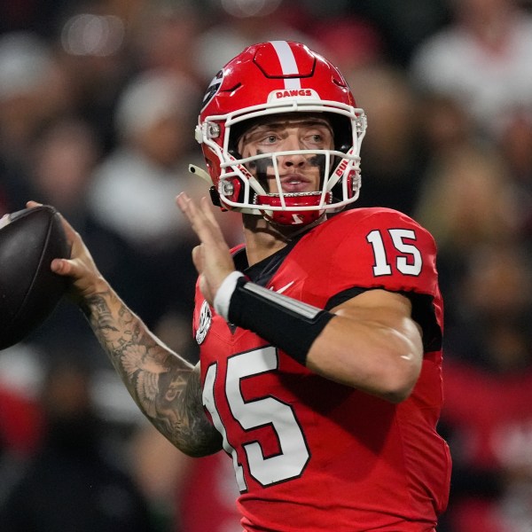 FILE - Georgia quarterback Carson Beck looks for an open receiver during the first half of an NCAA college football game against Tennessee, Nov. 16, 2024, in Athens, Ga. (AP Photo/John Bazemore, File)