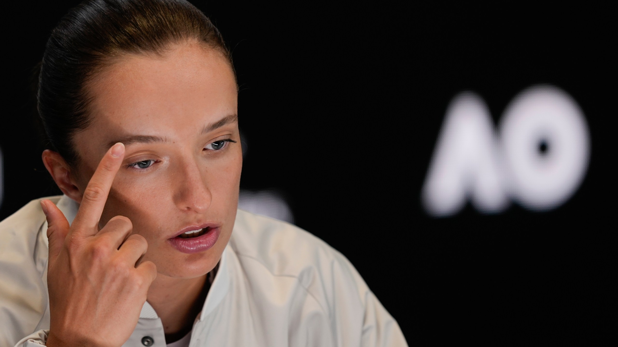 Poland's Iga Swiatek reacts during a press conference ahead of the Australian Open tennis championship in Melbourne, Australia, Friday, Jan. 10, 2025. (AP Photo/Ng Han Guan)