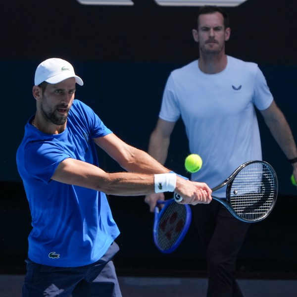 Serbia's Novak Djokovic is watched by his coach Andy Murray, right, during a practice session ahead of the Australian Open tennis championship in Melbourne, Australia, Thursday, Jan. 9, 2025. (AP Photo/Mark Baker)