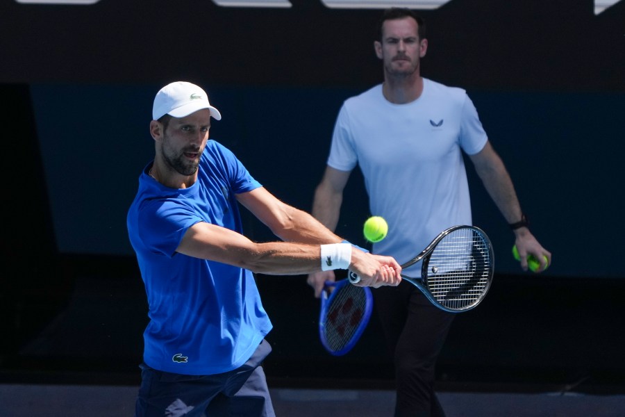 Serbia's Novak Djokovic is watched by his coach Andy Murray, right, during a practice session ahead of the Australian Open tennis championship in Melbourne, Australia, Thursday, Jan. 9, 2025. (AP Photo/Mark Baker)