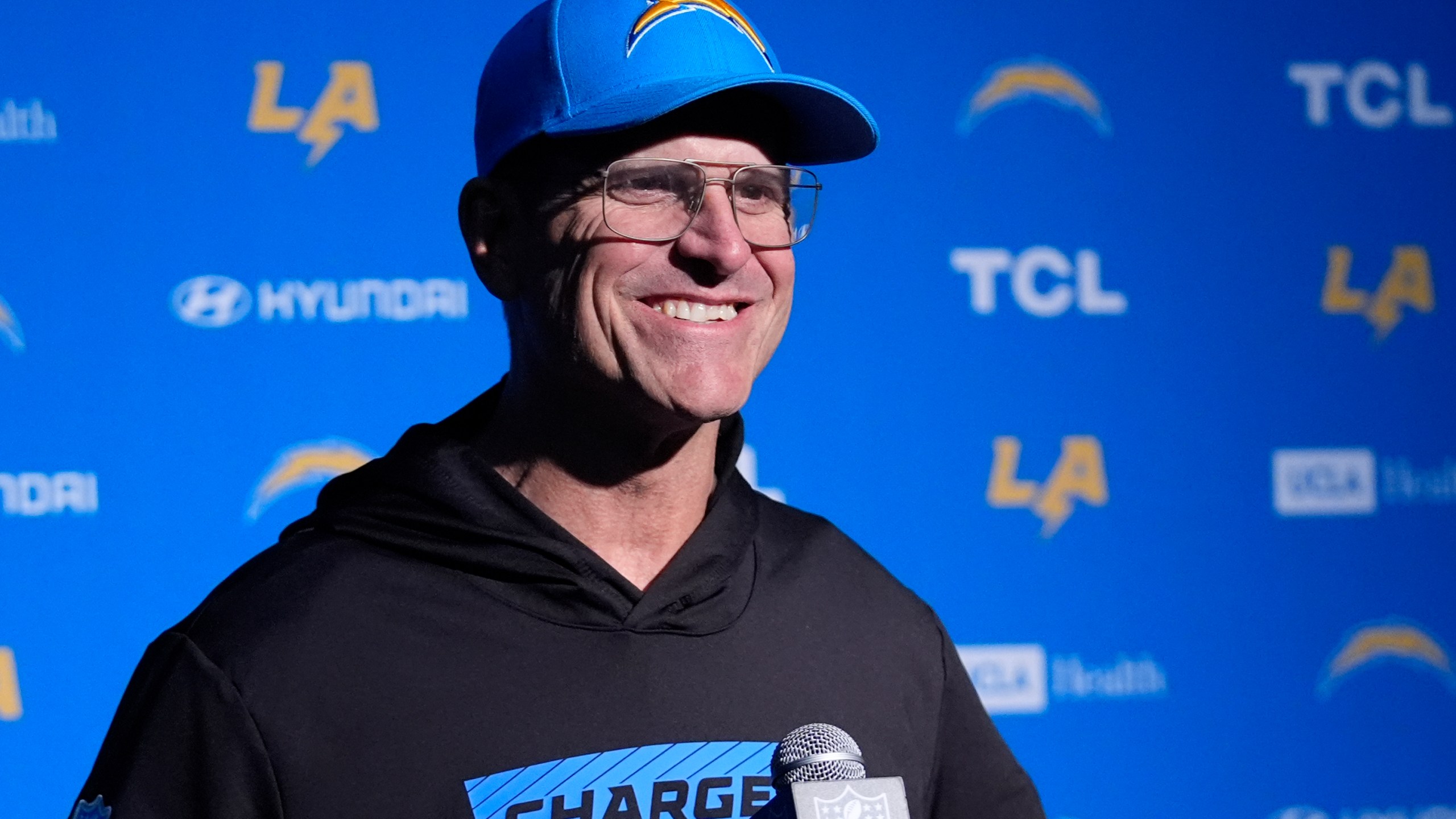 Los Angeles Chargers head coach Jim Harbaugh listens to a reporter's question during a news conference following an NFL football game, Saturday, Dec. 28, 2024, in Foxborough, Mass. (AP Photo/Robert F. Bukaty)