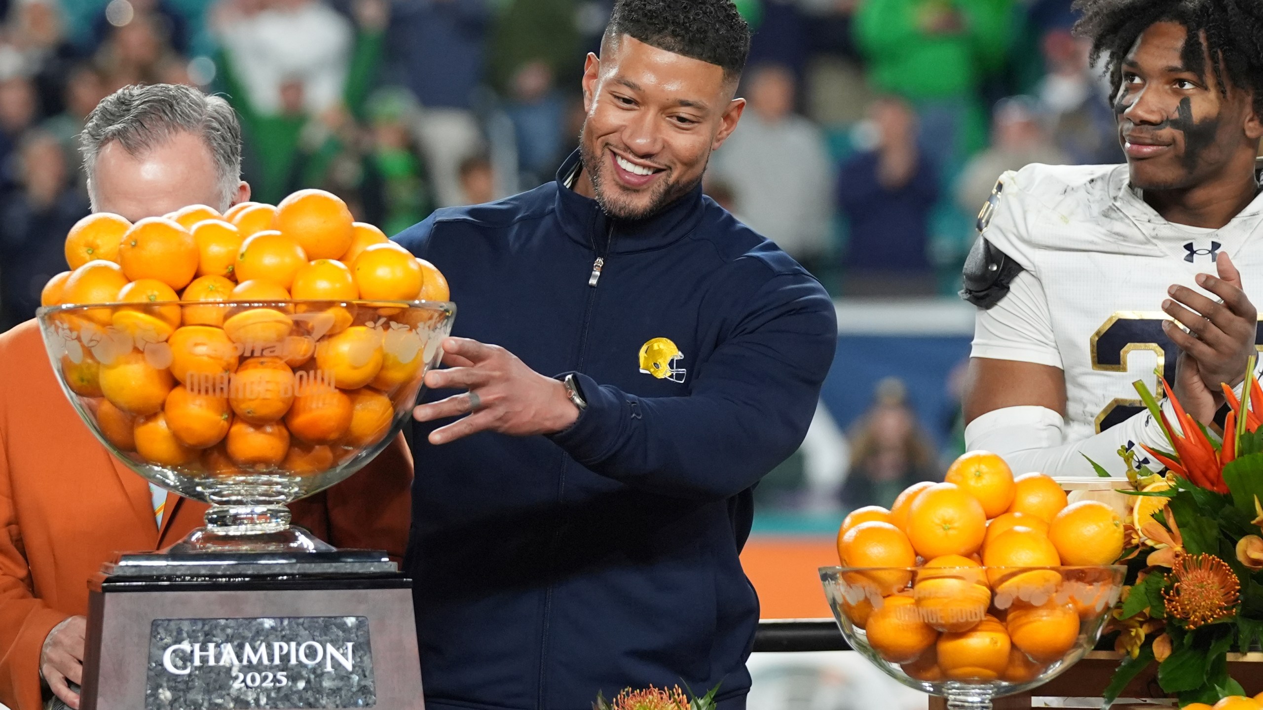 Notre Dame head coach Marcus Freeman touches the Orange Bowl trophy at the end of the Orange Bowl College Football Playoff semifinal game against Penn State, Thursday, Jan. 9, 2025, in Miami Gardens, Fla. (AP Photo/Lynne Sladky)